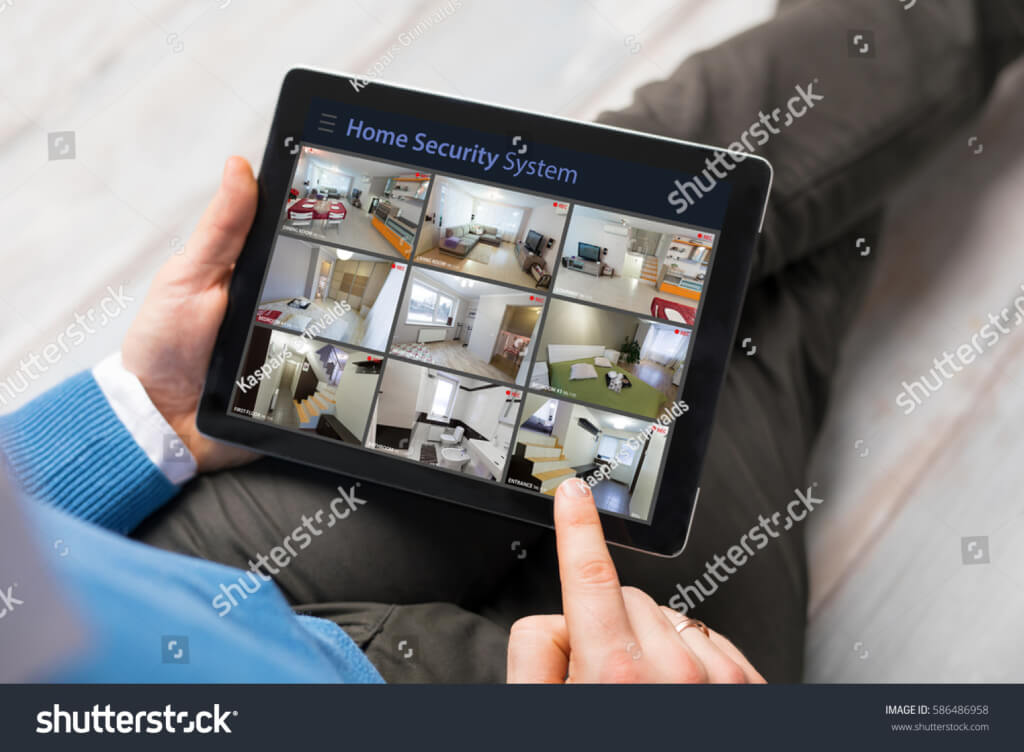 stock photo man looking at home security cameras on tablet computer 586486958 1024x752 - Services